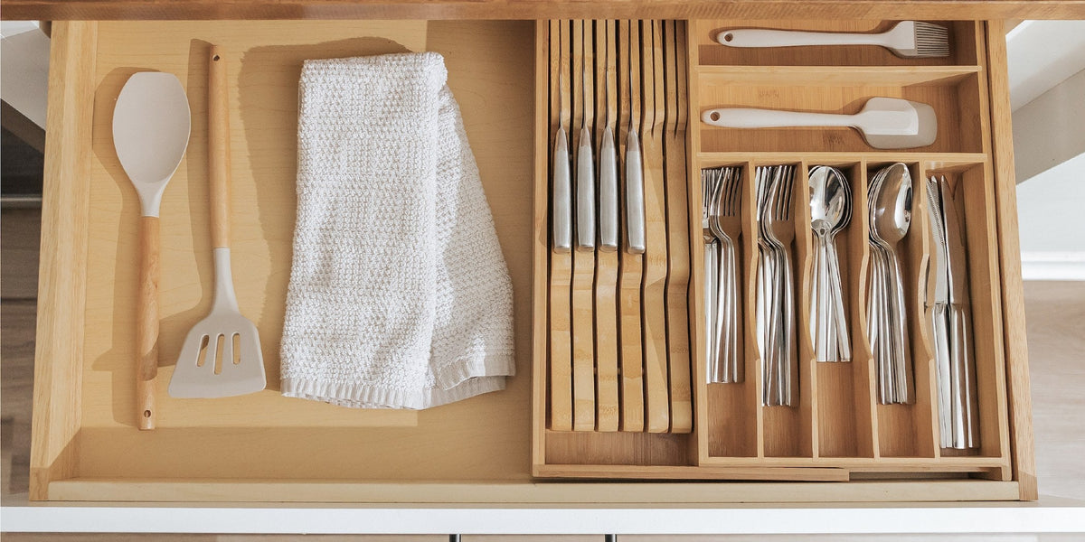 Kitchen drawer split between narrow organizer trays and an open bay